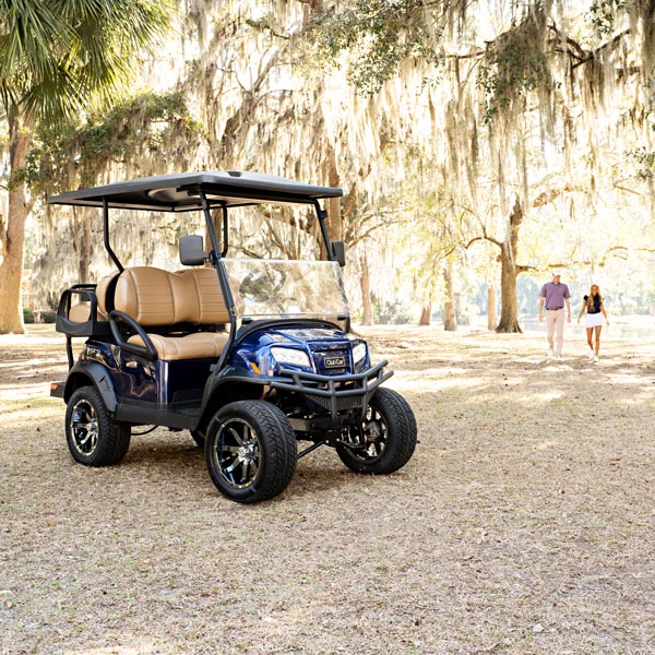 couple walking towards golf car